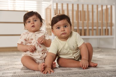 Photo of Cute little twin babies on floor at home