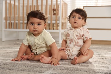 Photo of Cute little twin babies on floor at home