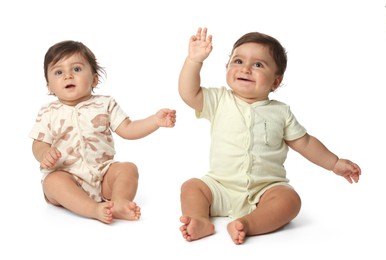 Photo of Cute little twin babies on white background