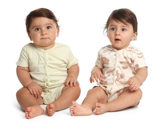 Photo of Cute little twin babies on white background