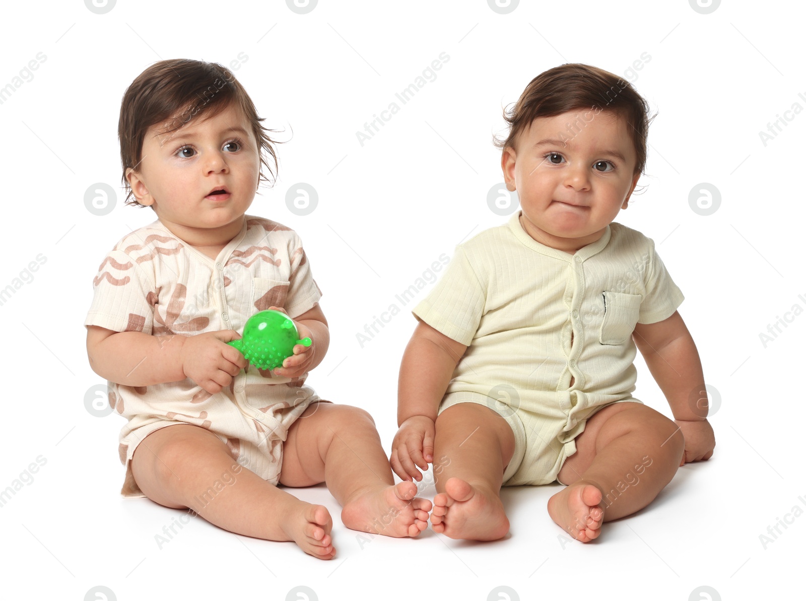 Cute little twin babies on white background Photo of Cute little twin babies on white background