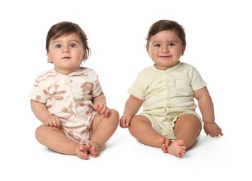 Photo of Cute little twin babies on white background