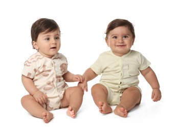 Photo of Cute little twin babies on white background