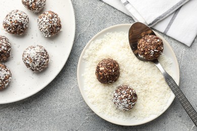 Photo of Making tasty chocolate candies with coconut flakes at grey table, flat lay