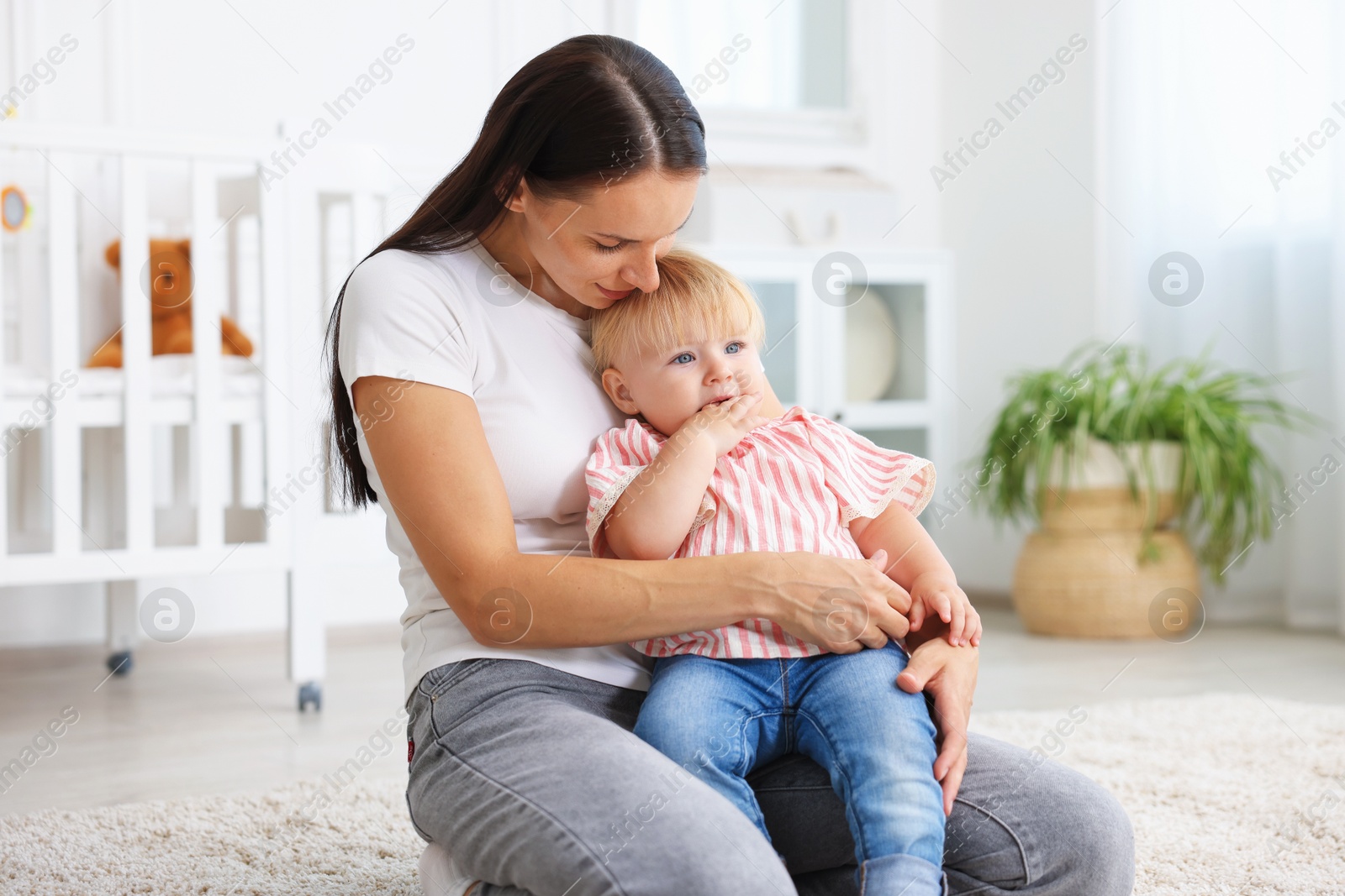 Mother with cute little baby on floor in room Photo of Mother with cute little baby on floor in room