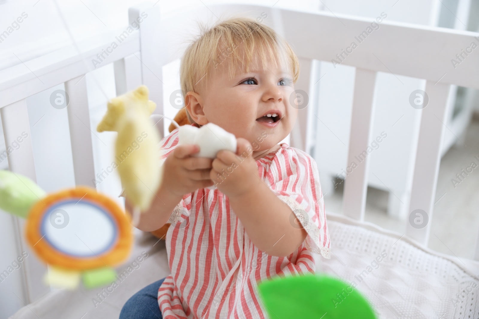 Cute little baby in crib in room Photo of Cute little baby in crib in room