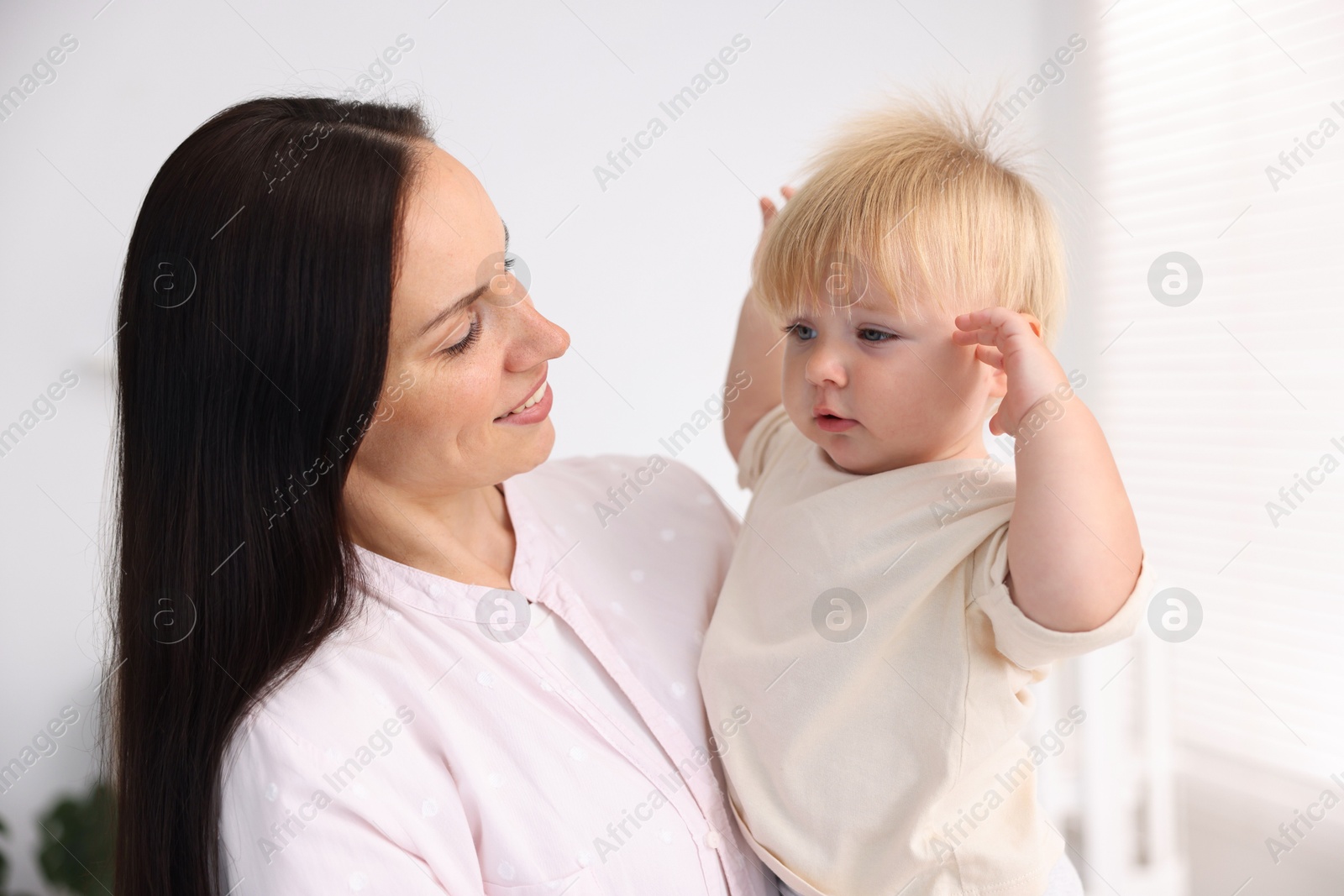 Mother and her cute little baby in room Photo of Mother and her cute little baby in room