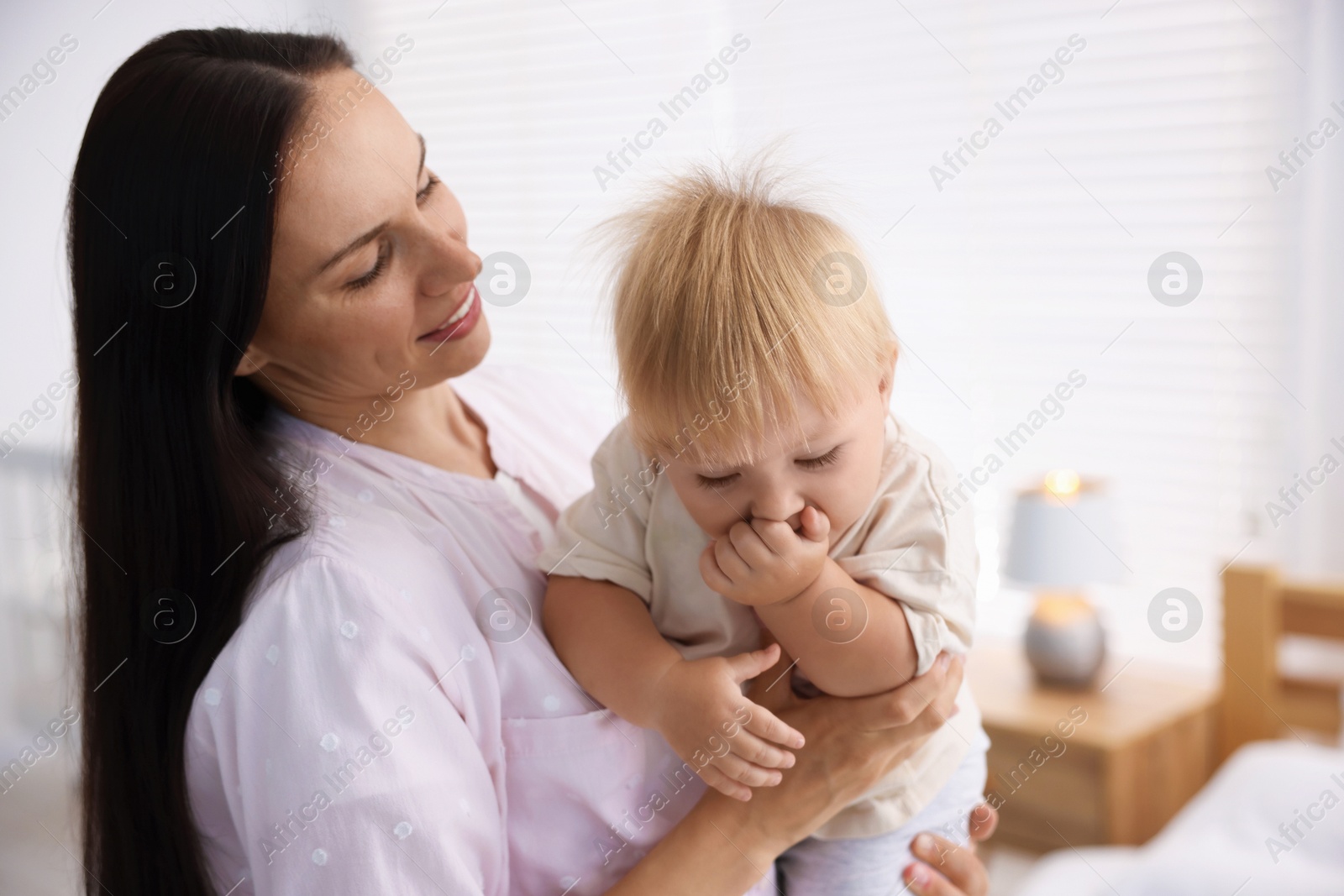 Mother and her cute little baby in room Photo of Mother and her cute little baby in room
