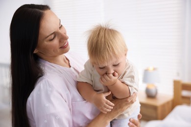 Photo of Mother and her cute little baby in room