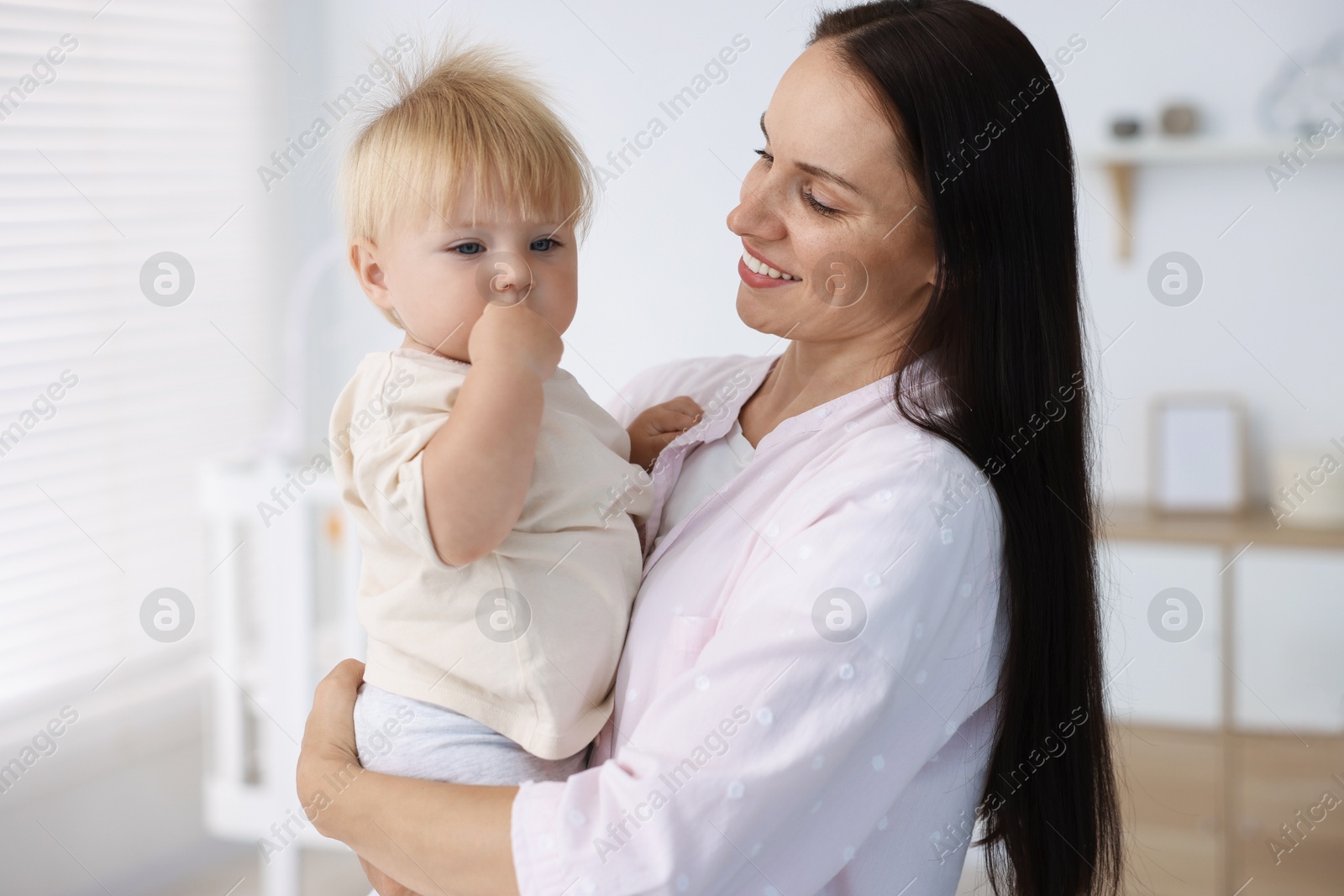 Mother and her cute little baby in room Photo of Mother and her cute little baby in room