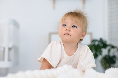 Photo of Cute little baby on bed in room, space for text