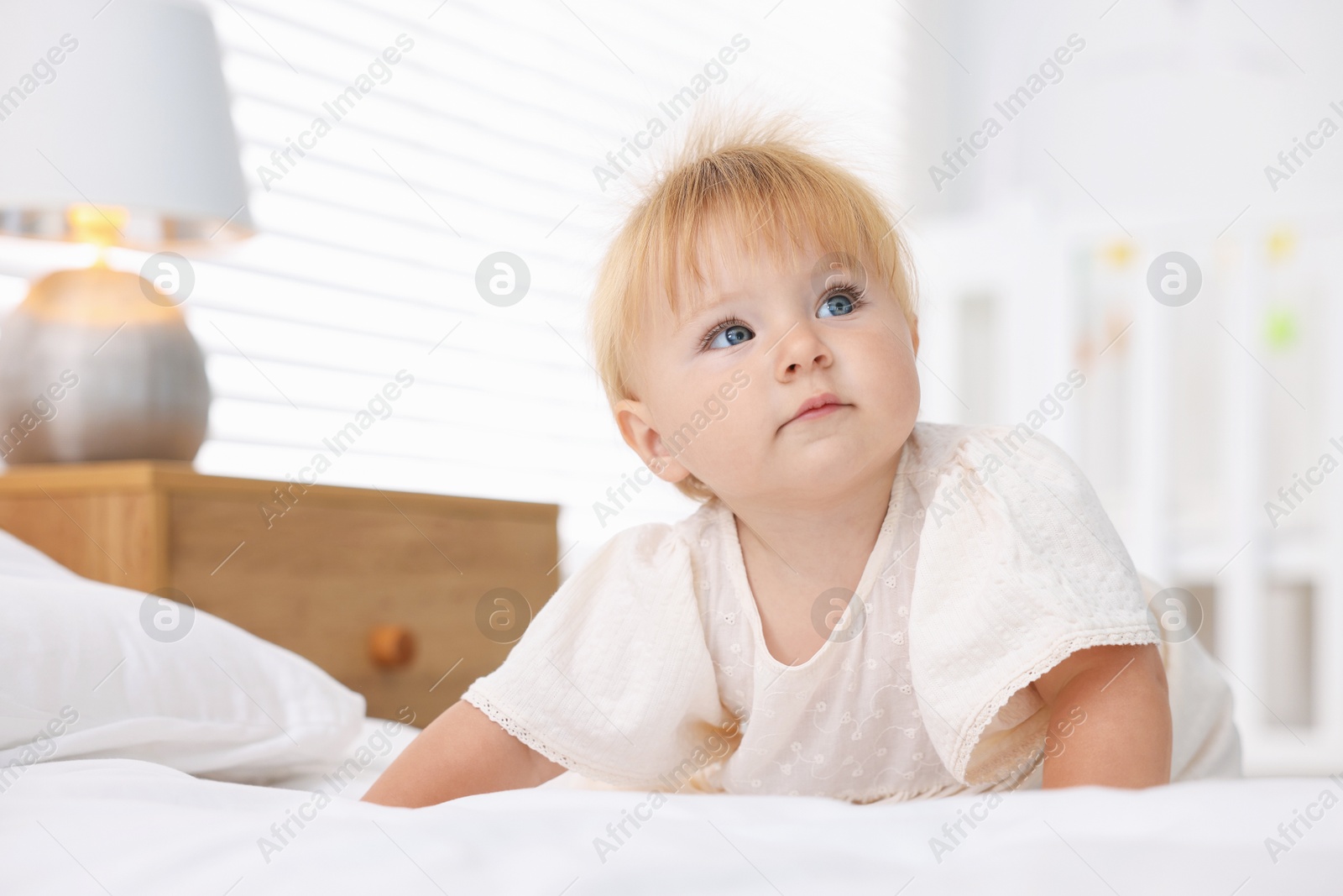 Cute little baby on bed in room Photo of Cute little baby on bed in room