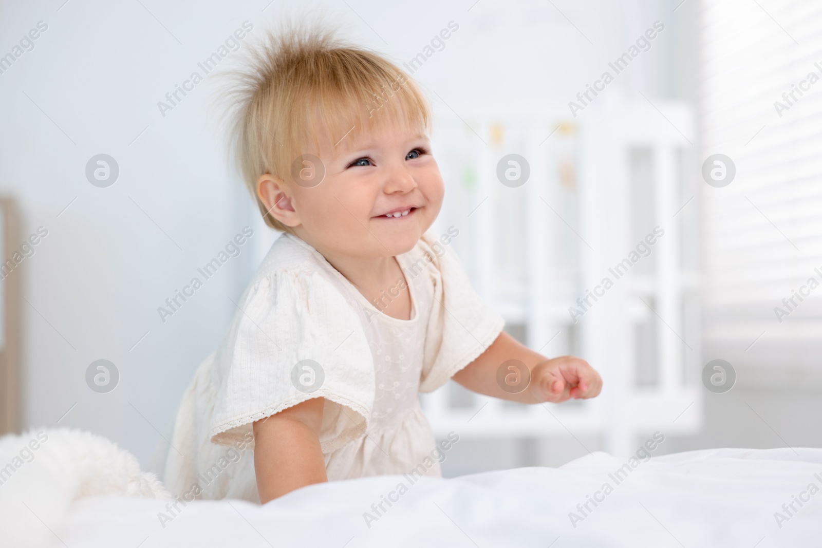 Cute little baby on bed in room Photo of Cute little baby on bed in room