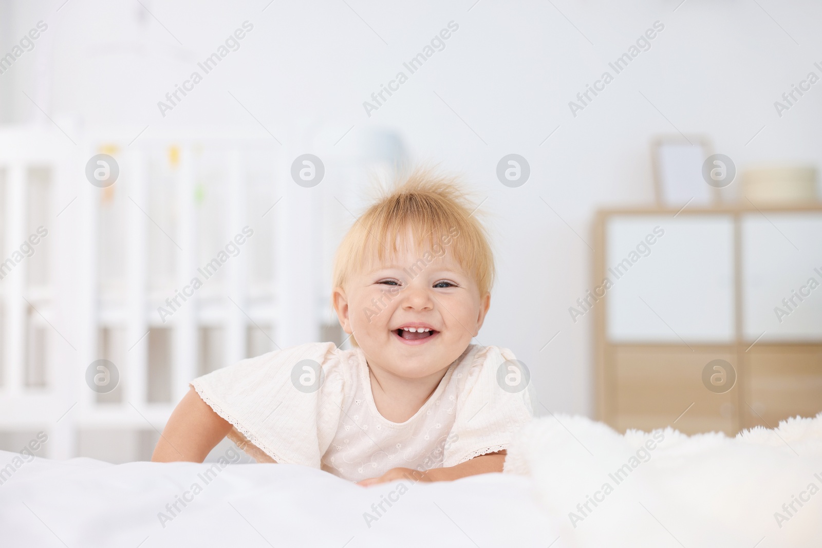 Cute little baby on bed in room Photo of Cute little baby on bed in room