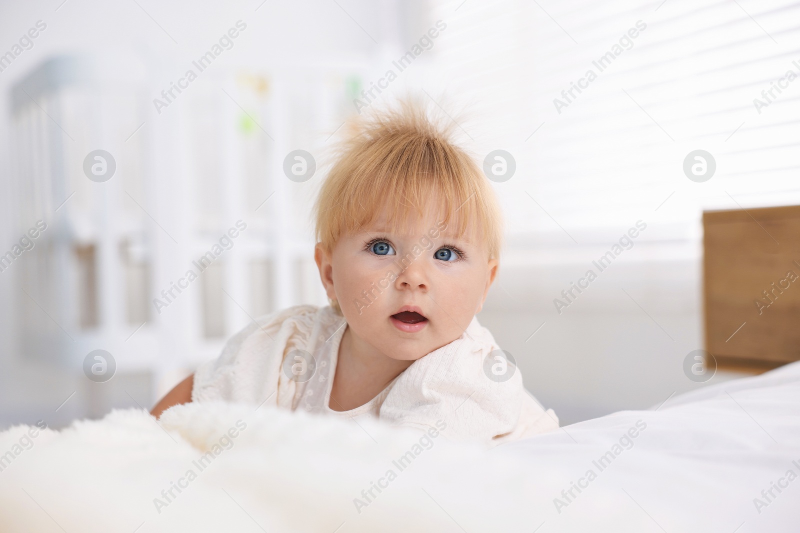 Photo of Cute little baby on bed in room