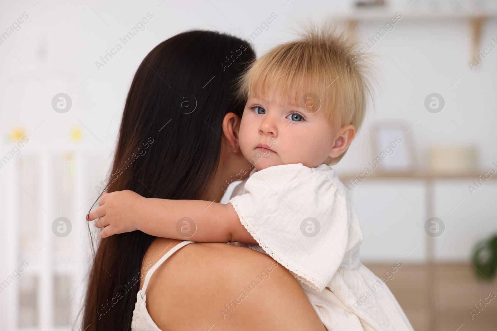 Mother and her cute little baby in room Photo of Mother and her cute little baby in room