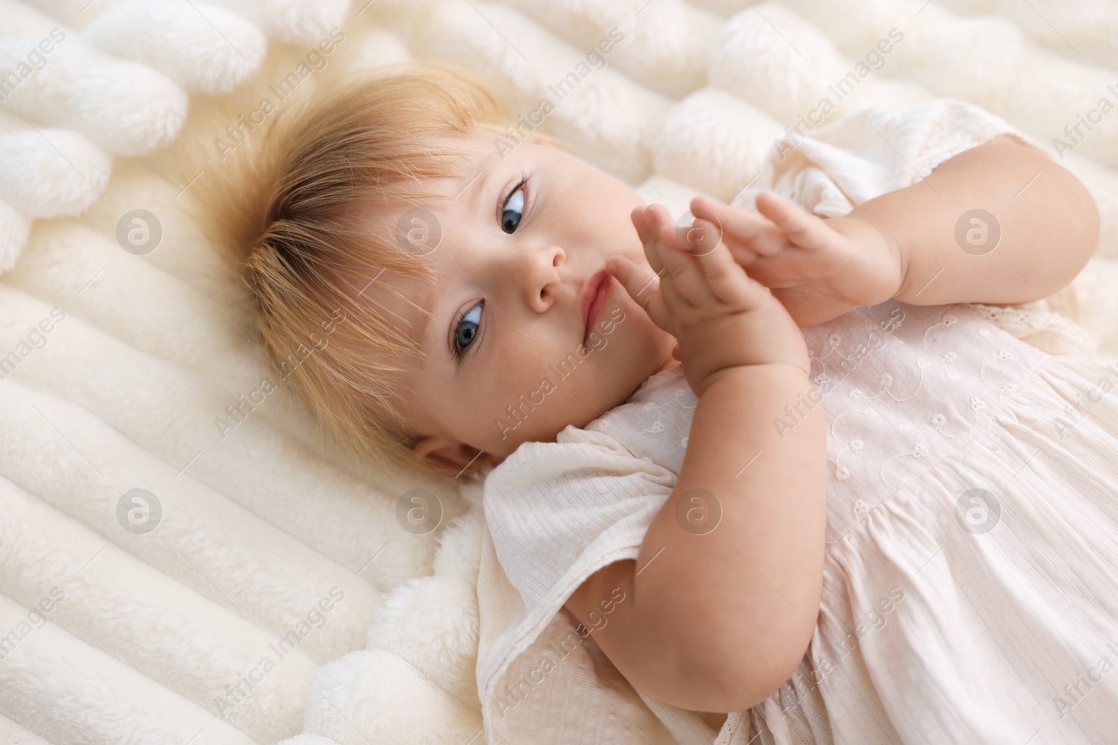 Cute little baby on bed in room, above view Photo of Cute little baby on bed in room, above view