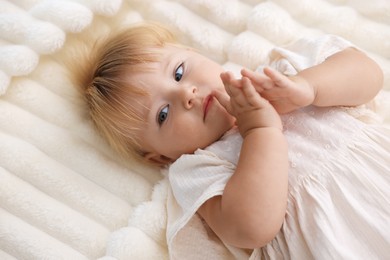 Photo of Cute little baby on bed in room, above view