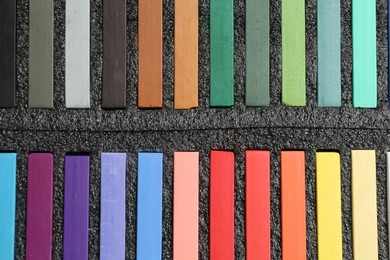Photo of Colorful chalk pastels in box, top view