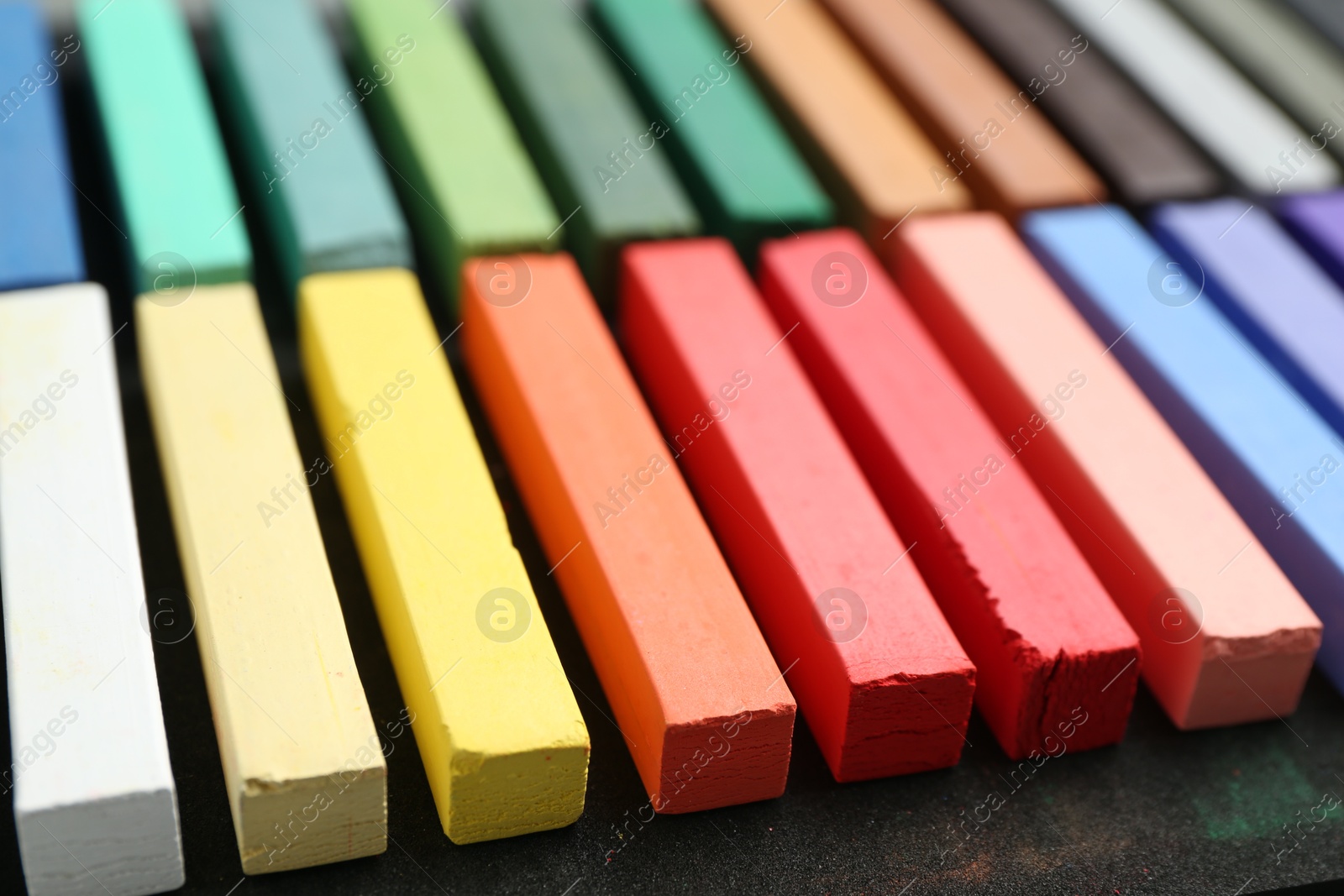 Photo of Set of colorful chalk pastels on table, closeup