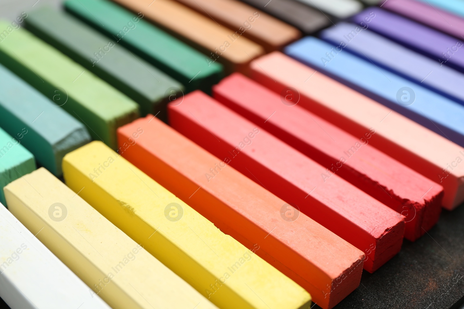 Photo of Set of colorful chalk pastels on table, closeup