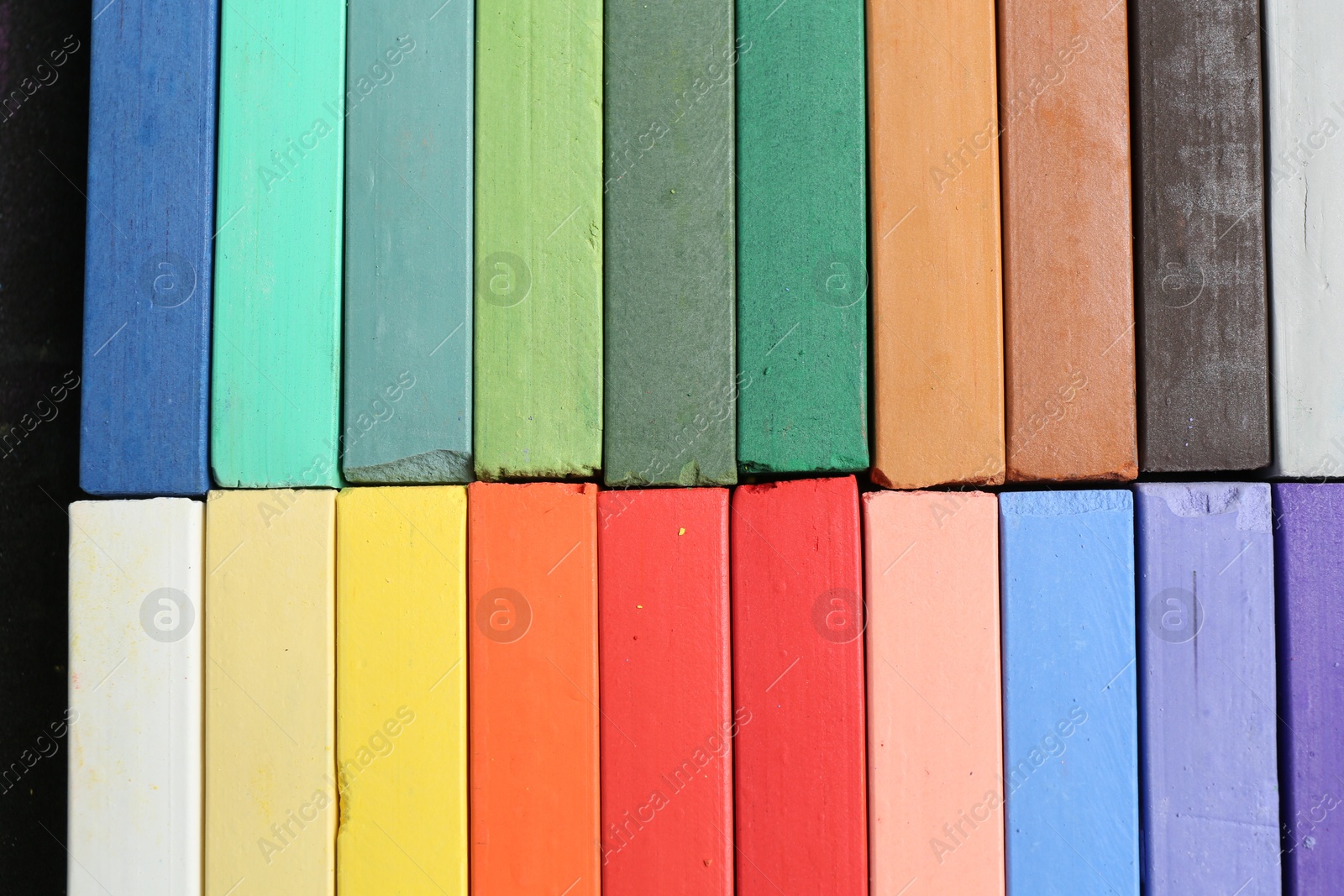 Photo of Colorful chalk pastels as background, top view