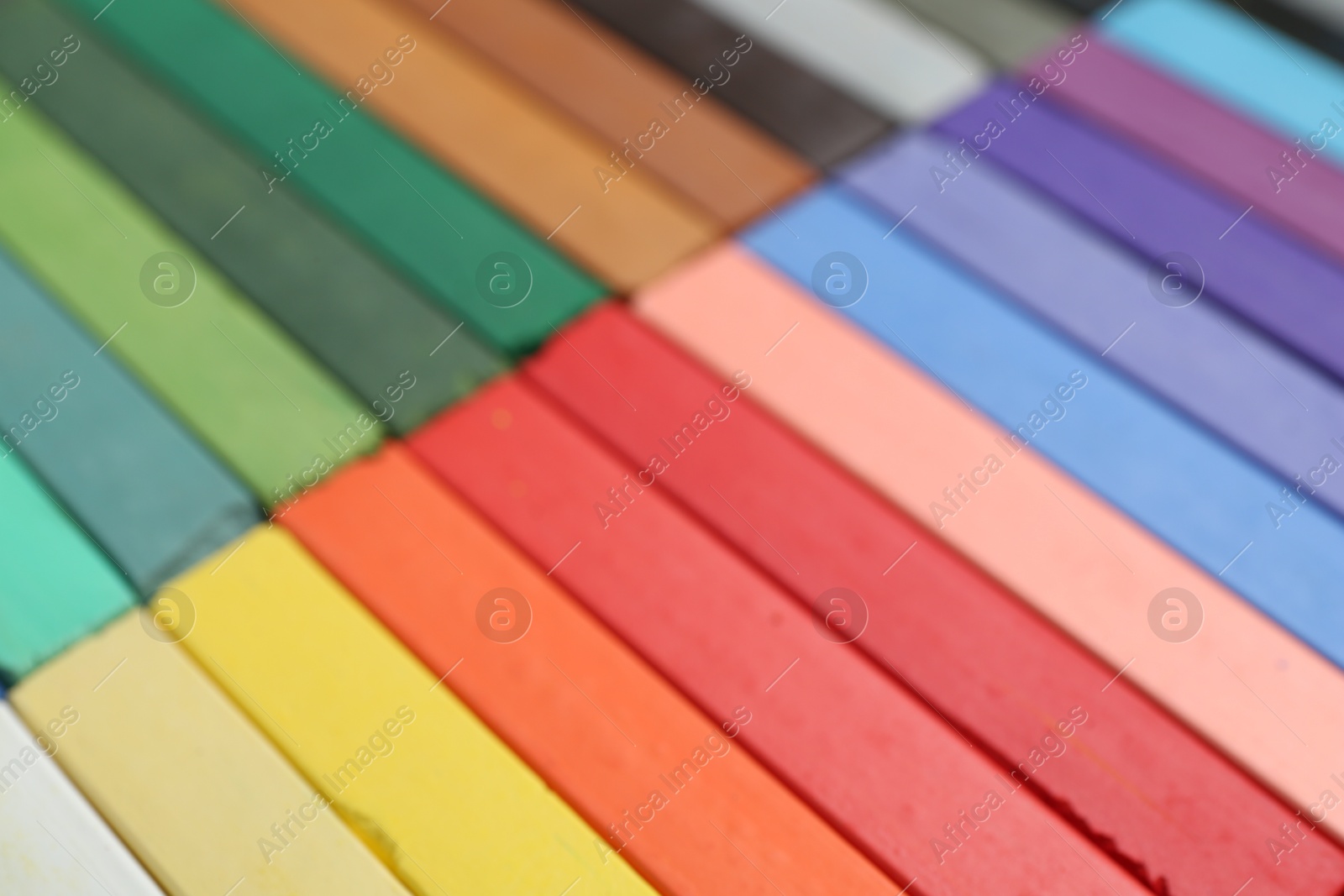 Photo of Set of colorful chalk pastels as background, closeup