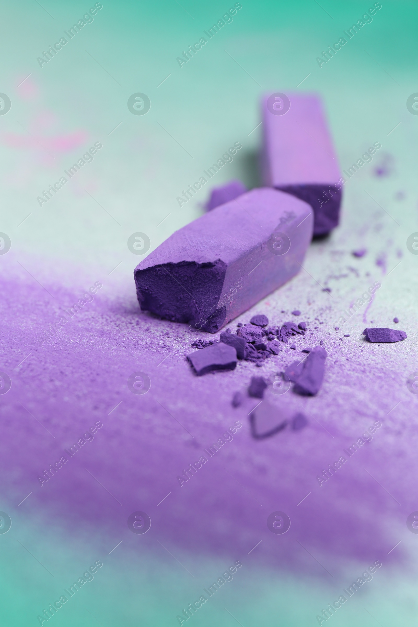 Photo of Violet chalk pastels and scribble on color background, closeup