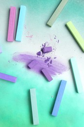 Photo of Colorful chalk pastels on color background, flat lay