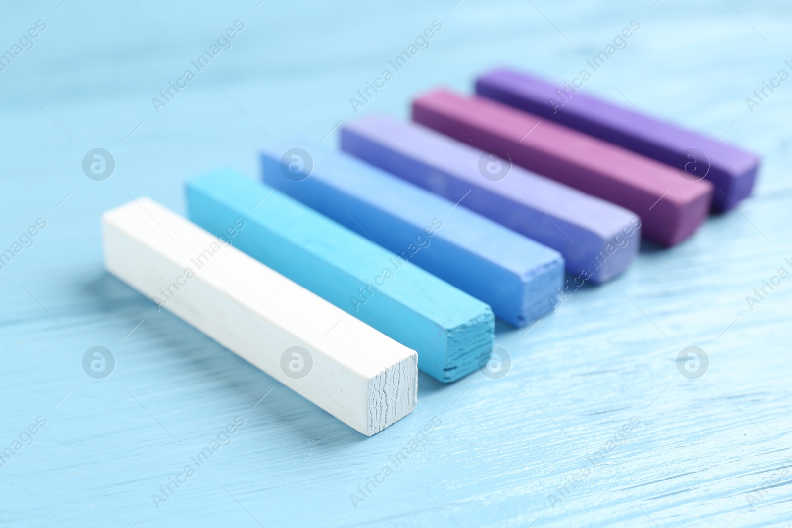 Colorful chalk pastels on light wooden table, closeup Photo of Colorful chalk pastels on light wooden table, closeup