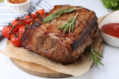 Photo of Delicious roast beef with rosemary, tomatoes and sauce on light table, closeup