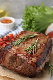 Photo of Delicious roast beef with rosemary on table, closeup
