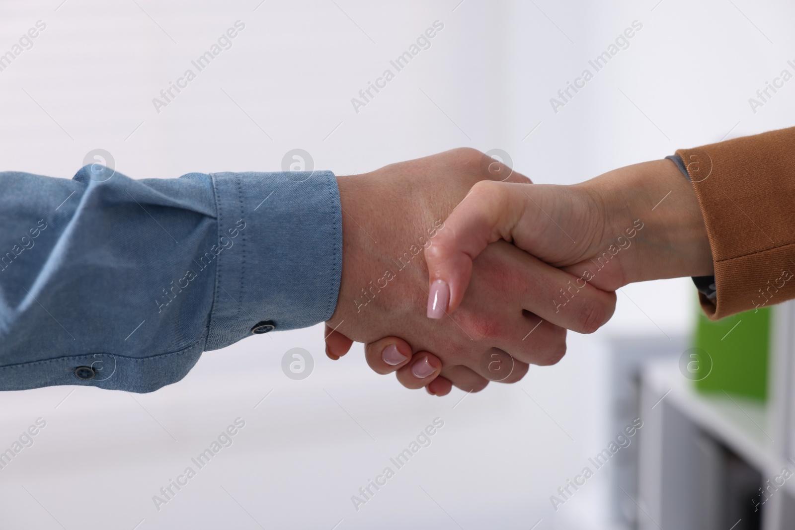 Business partners shaking hands in office, closeup Photo of Business partners shaking hands in office, closeup