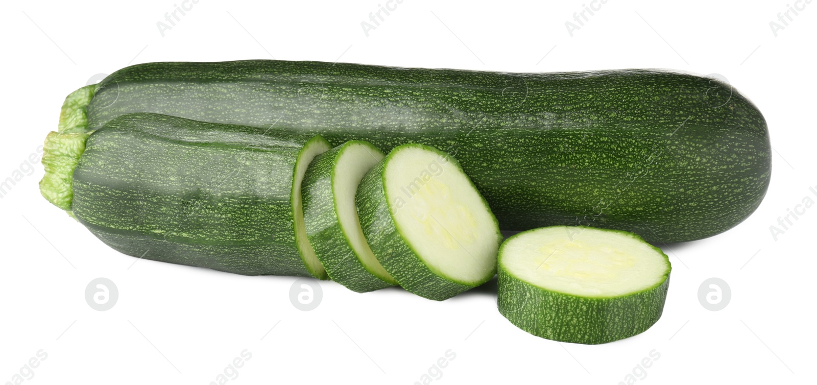Whole and cut fresh zucchinis isolated on white Photo of Whole and cut fresh zucchinis isolated on white