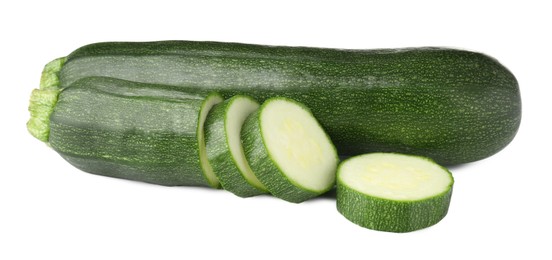 Photo of Whole and cut fresh zucchinis isolated on white