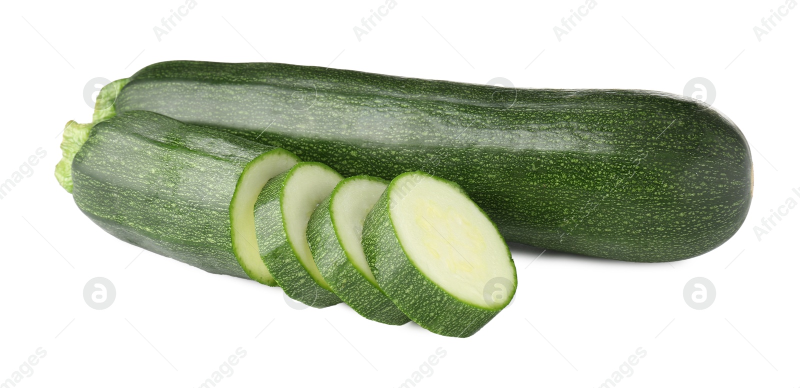 Whole and cut fresh zucchinis isolated on white Photo of Whole and cut fresh zucchinis isolated on white