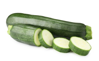 Photo of Whole and cut fresh zucchinis isolated on white