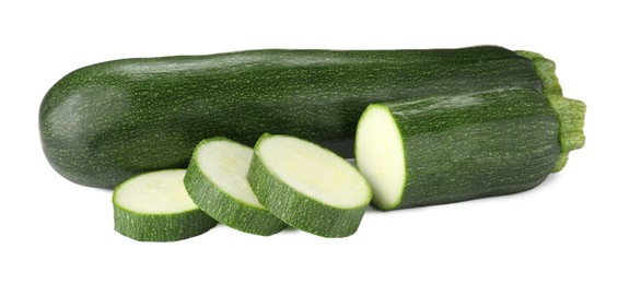 Photo of Whole and cut fresh zucchinis isolated on white