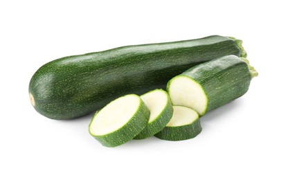 Photo of Whole and cut fresh zucchinis isolated on white