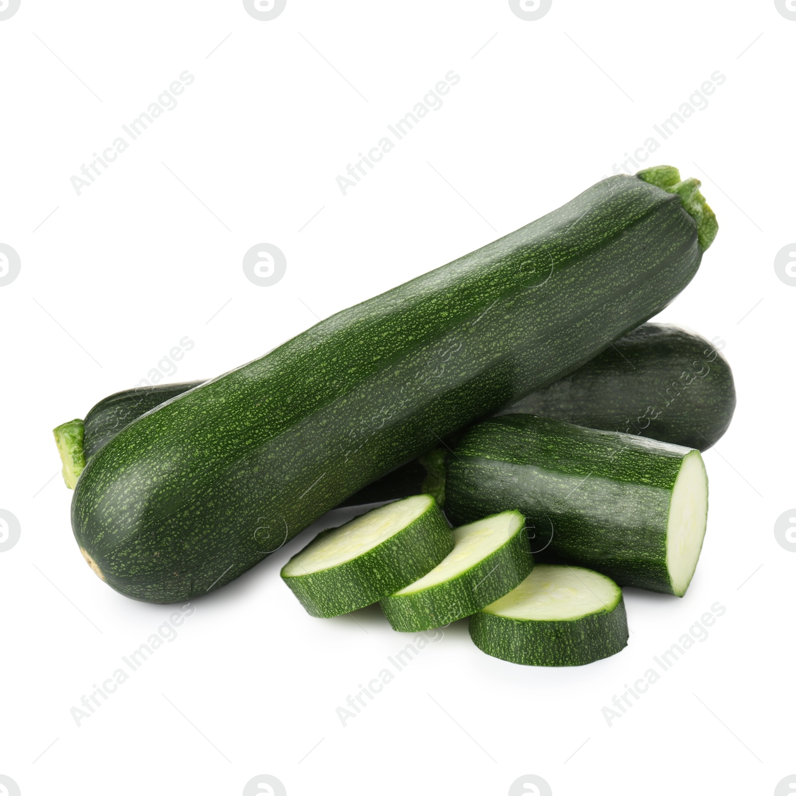 Whole and cut fresh zucchinis isolated on white Photo of Whole and cut fresh zucchinis isolated on white