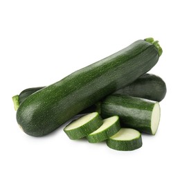 Photo of Whole and cut fresh zucchinis isolated on white