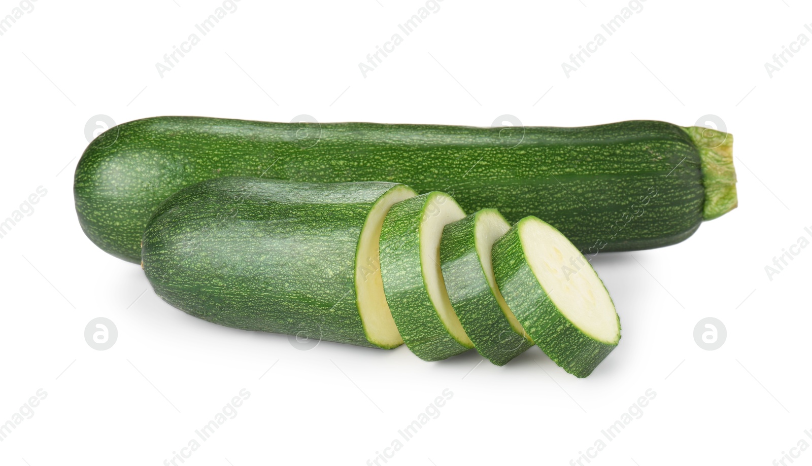 Whole and cut fresh zucchinis isolated on white Photo of Whole and cut fresh zucchinis isolated on white