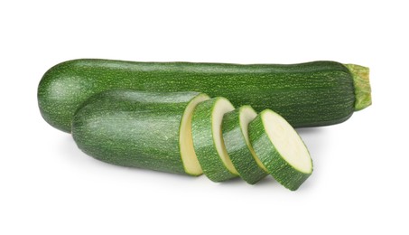 Photo of Whole and cut fresh zucchinis isolated on white