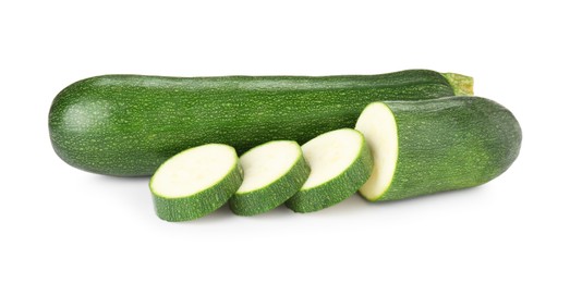 Photo of Whole and cut fresh zucchinis isolated on white