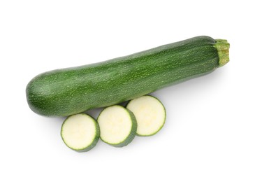 Photo of Whole and cut fresh zucchinis isolated on white, top view