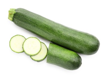 Photo of Whole and cut fresh zucchinis isolated on white, top view