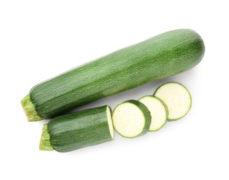 Photo of Whole and cut fresh zucchinis isolated on white, top view