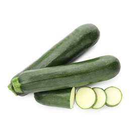 Photo of Whole and cut fresh zucchinis isolated on white, top view
