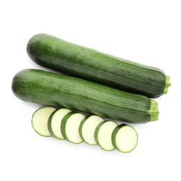 Photo of Whole and cut fresh zucchinis isolated on white, top view