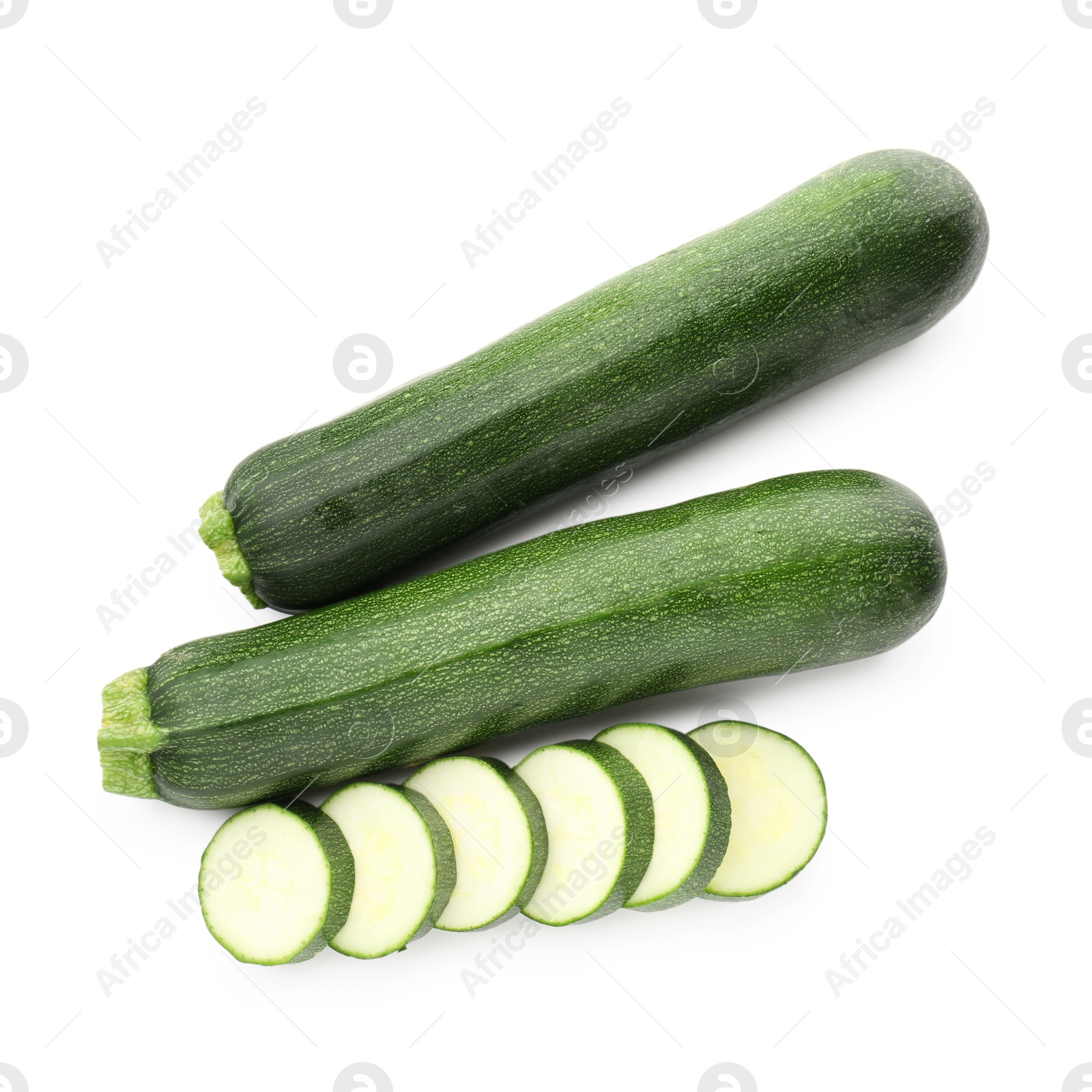 Whole and cut fresh zucchinis isolated on white, top view Photo of Whole and cut fresh zucchinis isolated on white, top view